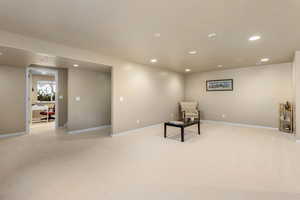 Unfurnished room with recessed lighting, light colored carpet, and baseboards