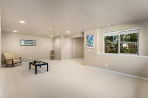 Unfurnished room with recessed lighting, light carpet, and baseboards