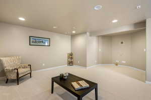 Living room featuring light carpet, recessed lighting, and baseboards