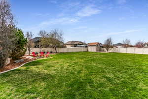 View of yard with a fenced backyard and a storage shed.