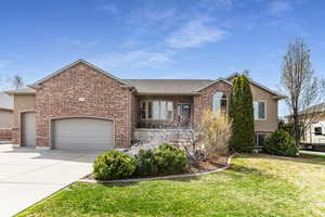 View of front with custom landscaping and large porch area.