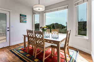 Dining space with wood flooring and new Anderson windows.  Access to covered deck and yard.