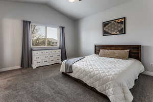 Primary bedroom with vaulted ceiling.