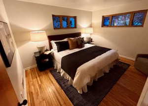 Bedroom with wood finished floors and baseboards