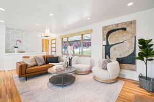 Living area with wood finished floors and recessed lighting
