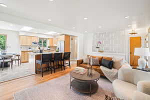 Living area featuring light wood-type flooring and recessed lighting
