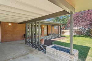 View of patio with a fire pit