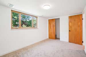 Unfurnished bedroom featuring baseboards, carpet flooring, and a closet