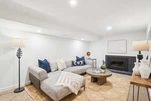 Living room featuring a fireplace, recessed lighting, and baseboards