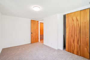 Unfurnished bedroom with carpet flooring and a closet