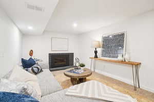 Living area featuring a fireplace, recessed lighting, and baseboards