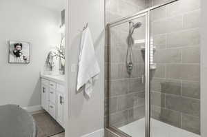 Bathroom featuring vanity, tile shower and glass enclosure