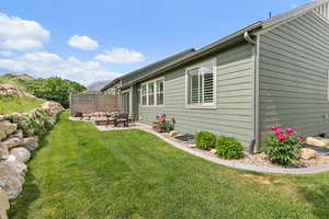 Secluded back yard with a deck and concrete patio