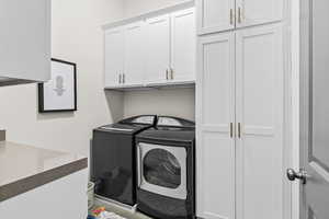Washroom with additional cabinet space and quartz counter top
