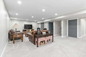 Large basement family room featuring multiple extra deep closets, recessed lighting, and light colored carpet