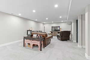 Large basement family room featuring multiple extra deep closets, recessed lighting, and light colored carpet