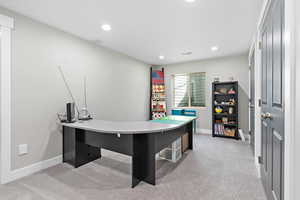 Basement office space featuring light colored carpet and recessed lighting