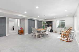 Large basement family room featuring multiple extra deep closets, recessed lighting, and light colored carpet