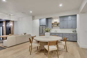Dining room featuring light wood-style flooring and recessed lighting
