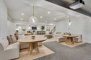 Living area with recessed lighting, stairway, and light wood-style floors