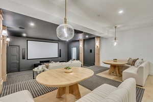 Home theater room with recessed lighting and light wood-style floors