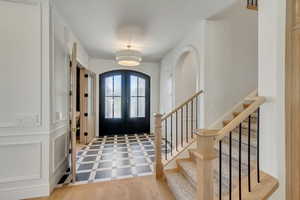 Foyer entrance with french doors and stairs