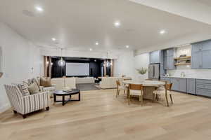Dining room with light wood finished floors and recessed lighting