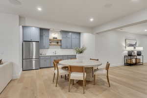Dining space featuring light wood-type flooring and recessed lighting