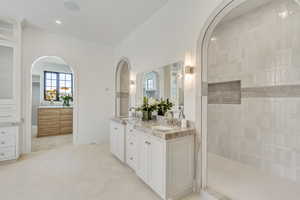 Bathroom with double vanity, recessed lighting, tile patterned floors, and a walk in shower