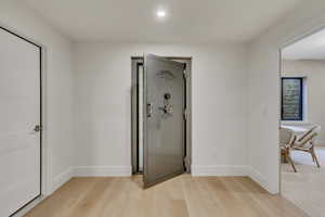 Hall featuring light wood-style flooring and recessed lighting