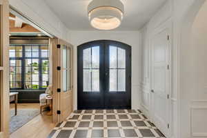 Entrance foyer with arched walkways, french doors, and plenty of natural light