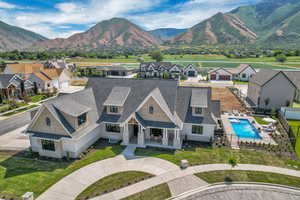 Aerial perspective of suburban area with a mountain backdrop and a pool area