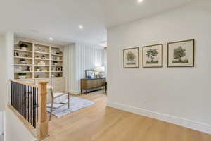 Hall featuring light wood-style flooring and recessed lighting