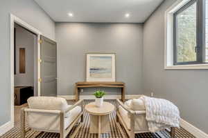 Sitting room featuring baseboards and recessed lighting