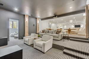 Carpeted home theater featuring recessed lighting and decorative columns