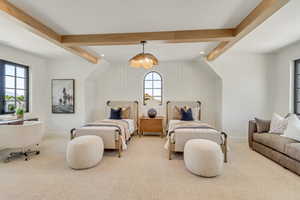 Carpeted bedroom with beamed ceiling