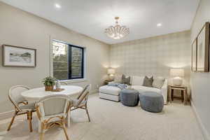 Bedroom with a chandelier, recessed lighting, and light colored carpet