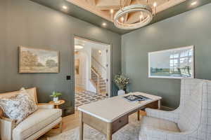 Office space with a chandelier, arched walkways, recessed lighting, and a towering ceiling