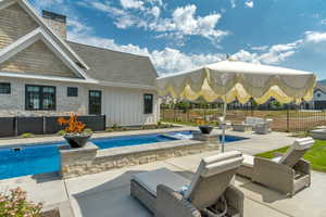 View of swimming pool with a patio and an outdoor living space