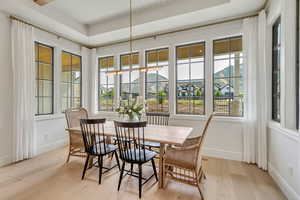 Dining space with light wood-style floors, healthy amount of natural light, and baseboards