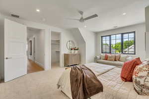 Bedroom featuring recessed lighting, light carpet, ceiling fan, a spacious closet, and a closet