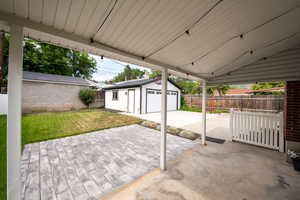 View of patio / terrace with a garage and an outdoor structure