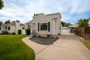 View of front of home featuring a garage, an outbuilding, and entry steps