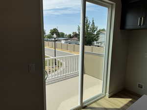 Doorway featuring healthy amount of natural light and wood finished floors