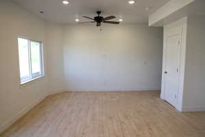 Unfurnished room with recessed lighting, ceiling fan, light wood finished floors, baseboards, and a smoke detector