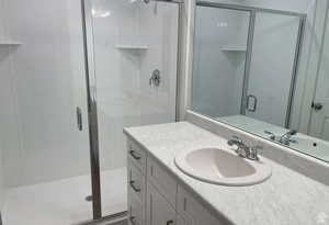 Bathroom featuring vanity and a stall shower