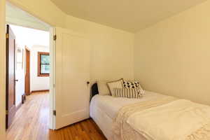 Bedroom featuring wood finished floors and baseboards