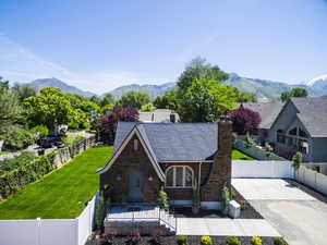 Tudor-style house with brick siding, a mountain view, and a chimney