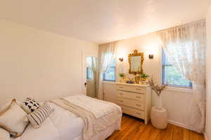Bedroom featuring light wood-style flooring and baseboards