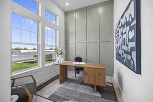 Home office featuring baseboards, a decorative wall, wood finished floors, and recessed lighting